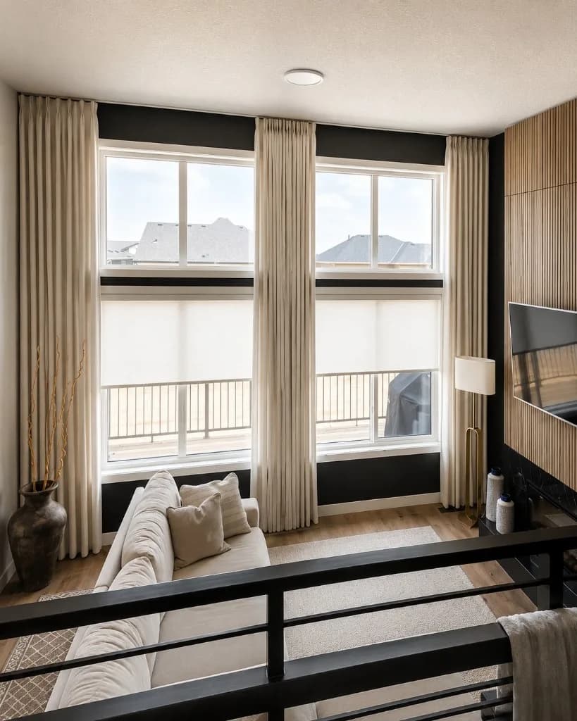 Sheer floor-to-ceiling drapery in a bright Your City living room