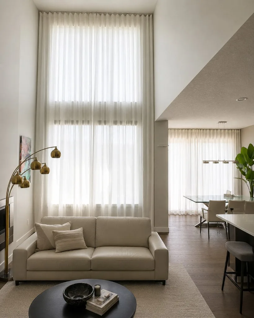 Sheer drapery over patio doors in an elegant Your City dining room
